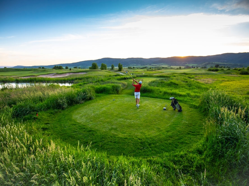 Golfer teeing off